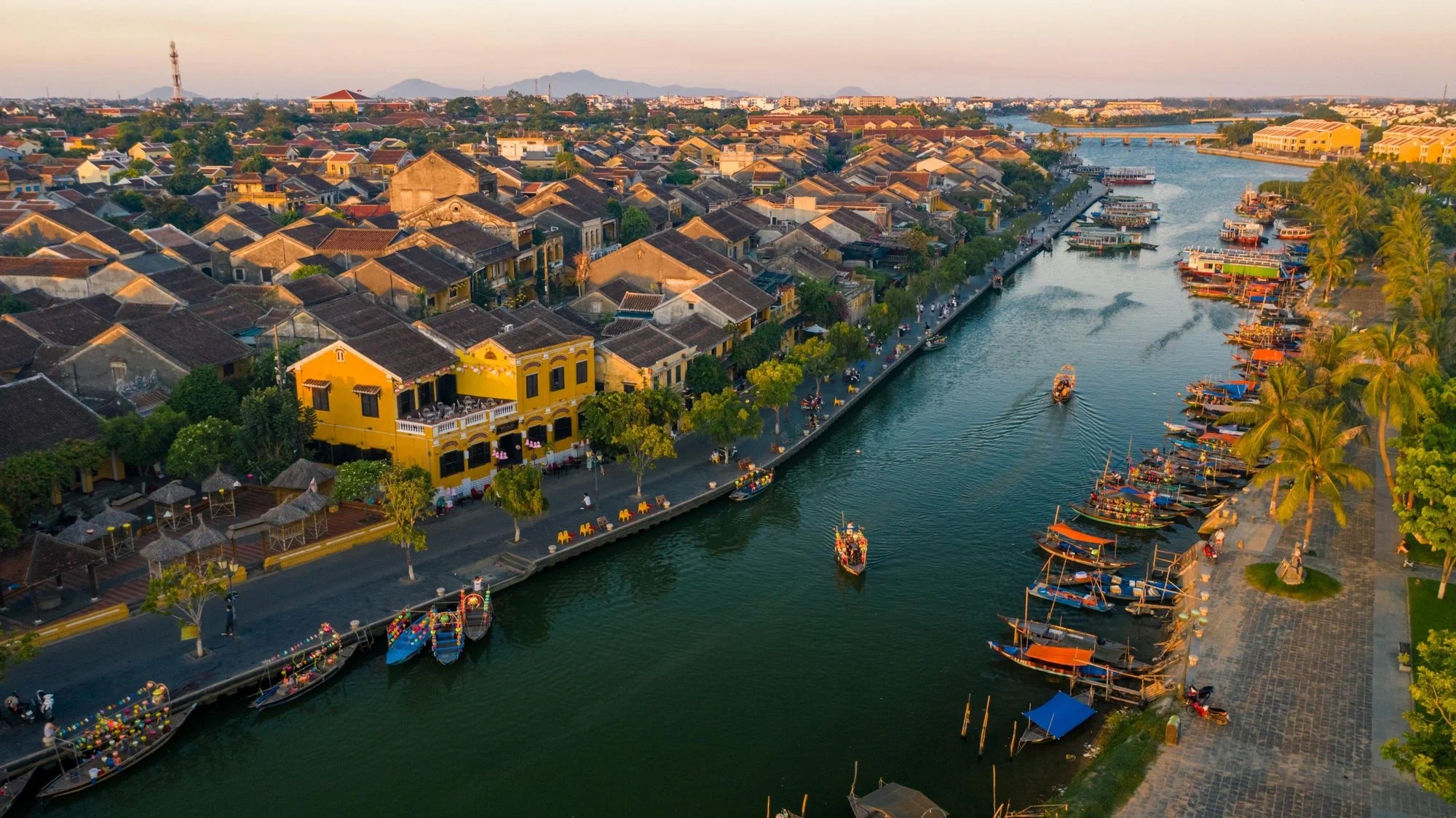 A scenic view of the yellow ancient houses and lantern-lit streets in Hoi An Ancient Town UNESCO World Heritage Site