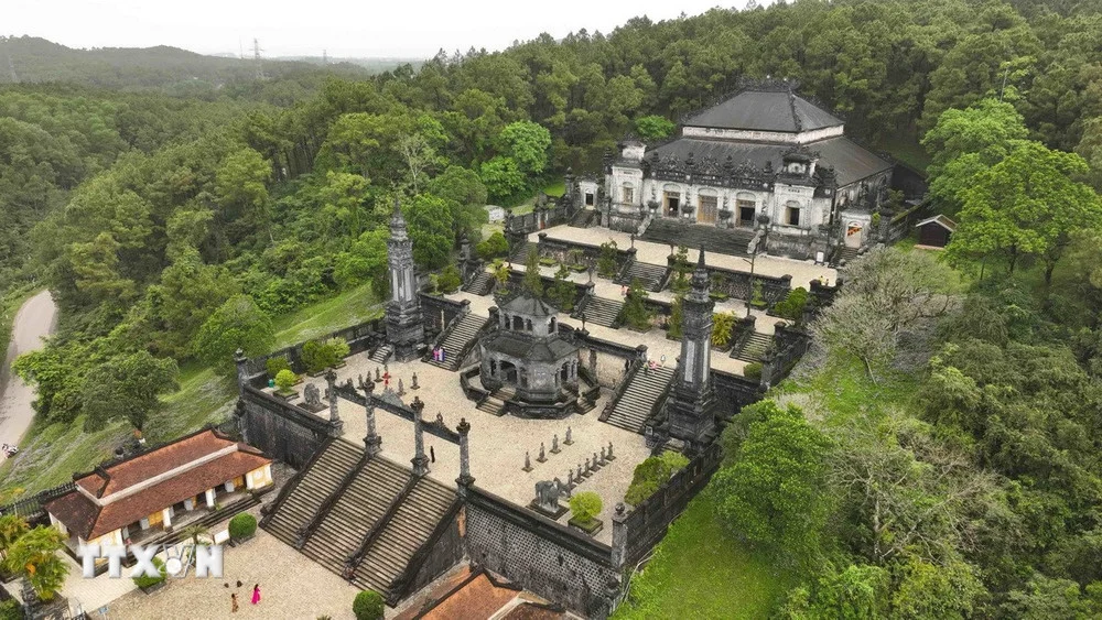The unique blend of Western and Eastern architecture featuring stone mandarin statues at the entrance of Khai Dinh Tomb in Hue