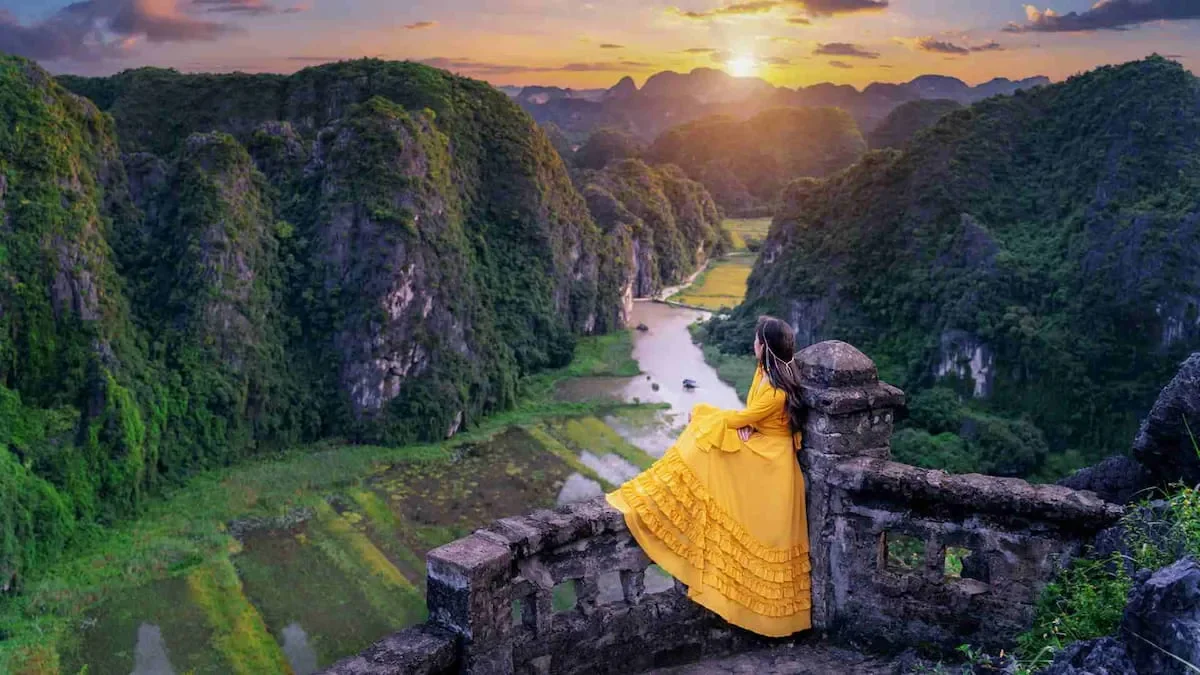 Breathtaking panoramic view of the winding river and limestone mountains seen from the dragon statue at the top of Mua Cave.