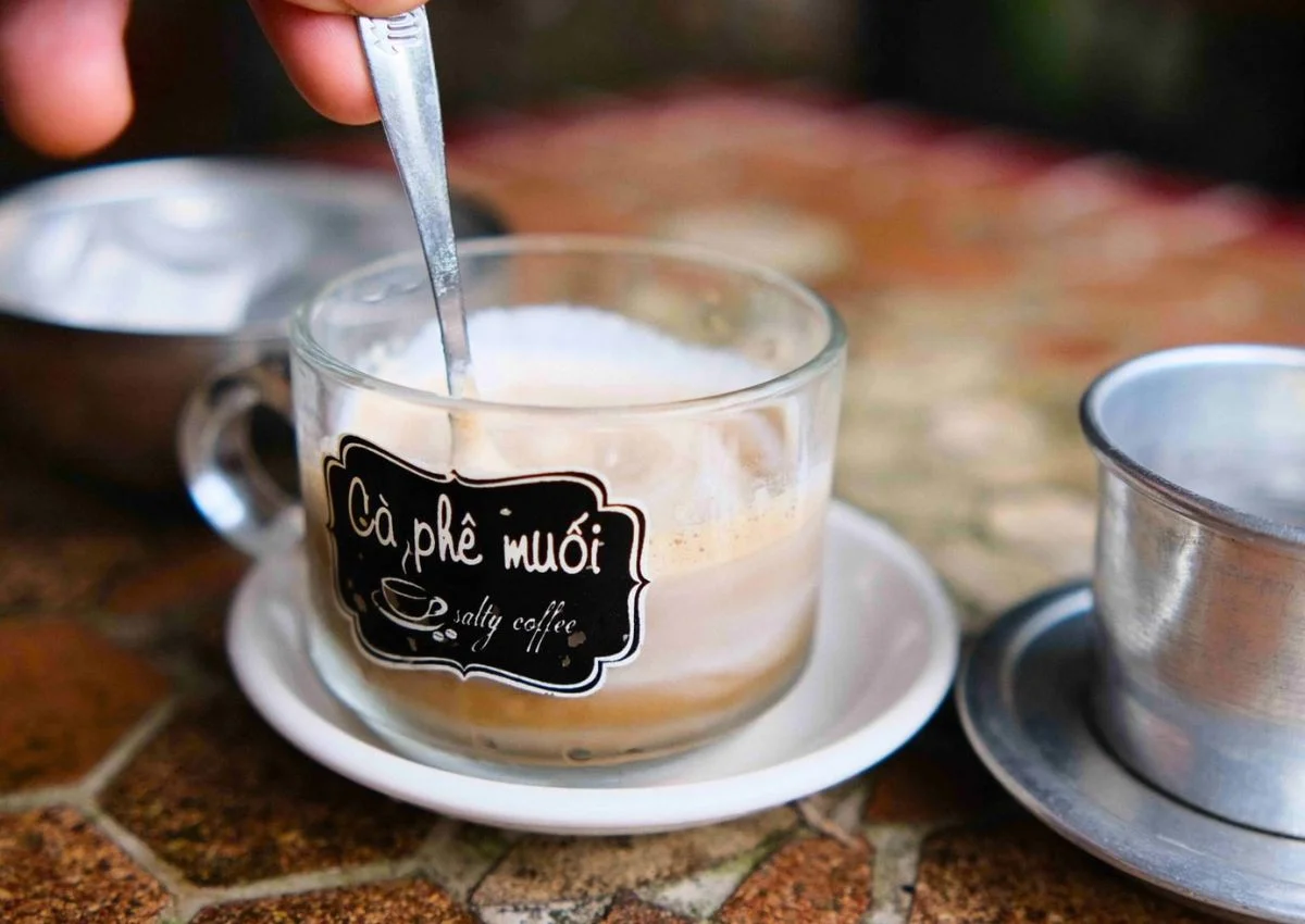 A glass of Vietnamese Salt Coffee in Hue - a must-try local treat after taking the bus from Phong Nha to Hue.