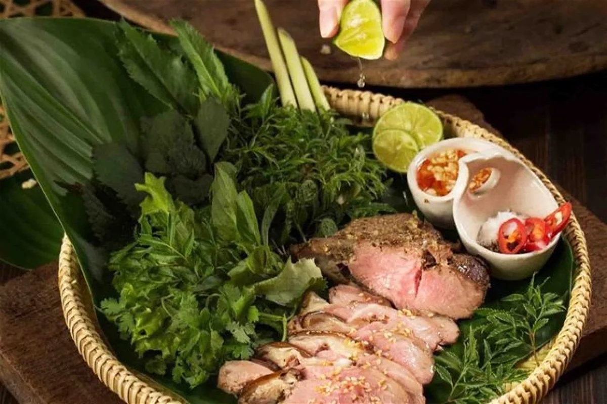 A platter of rare-cooked mountain goat meat served with sesame seeds, ginger, and fresh herbs.