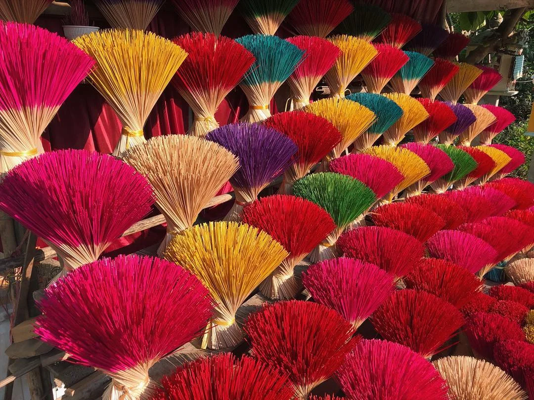 Symmetrical bundles of multi-colored incense sticks arranged like flowers in Thuy Xuan village