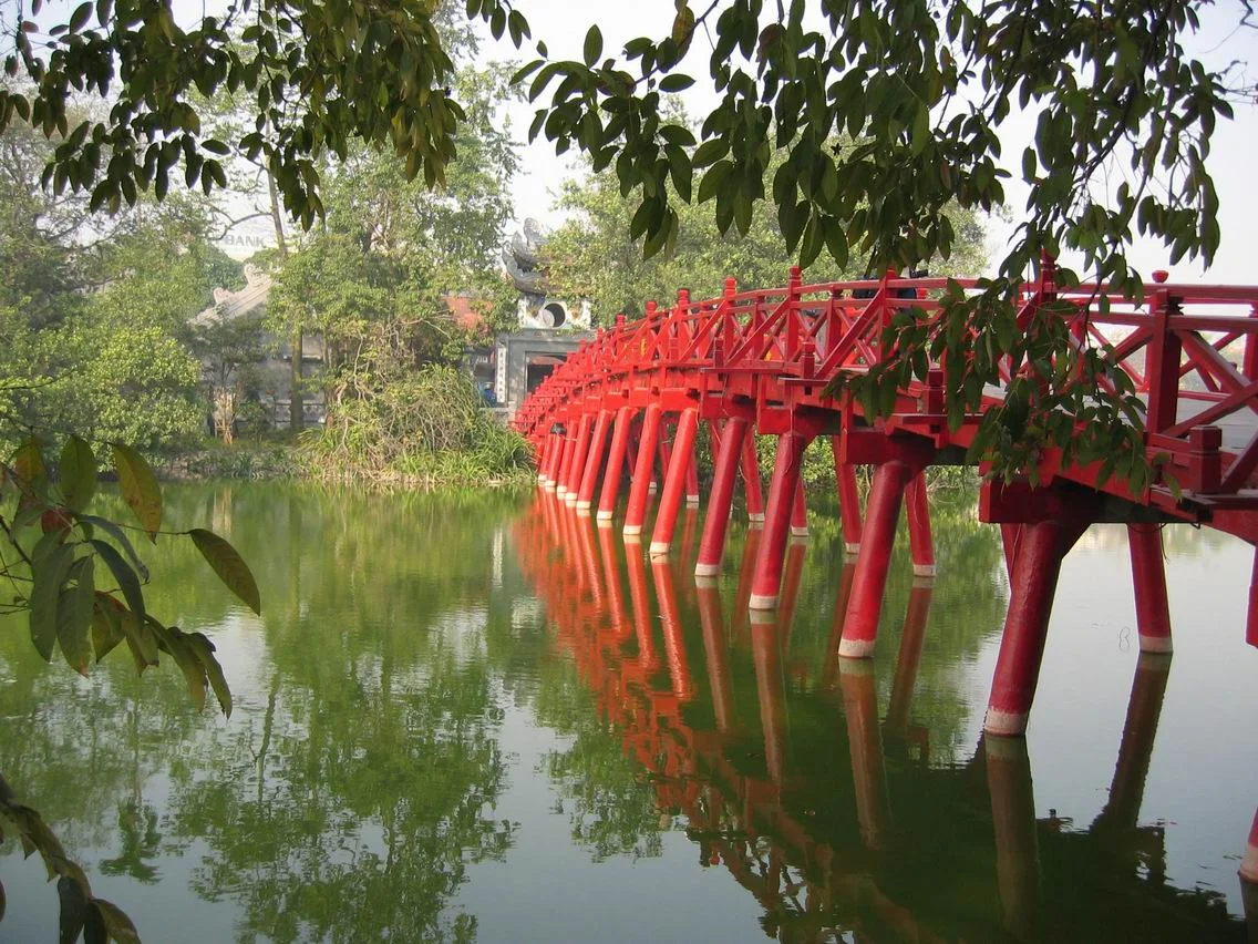 The iconic red The Huc Bridge, a top attraction for tourists visiting the capital via the Ninh Binh to Hanoi bus
