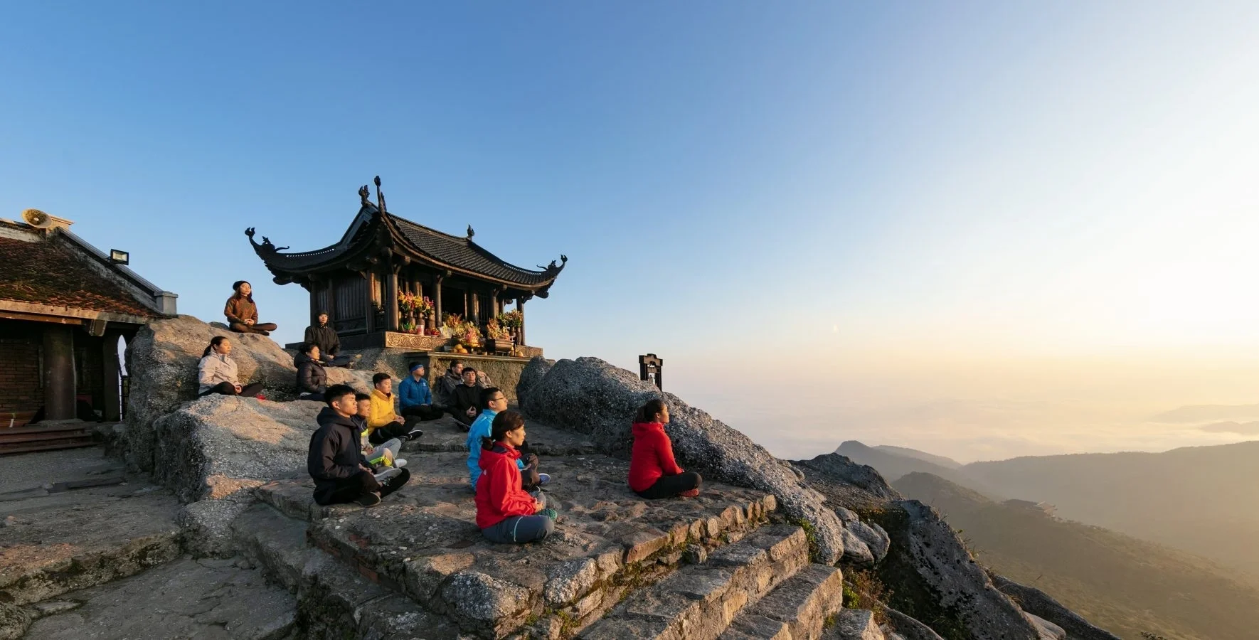 The sacred peaks of Yen Tu Mountain and the traditional architecture of Hanoi.